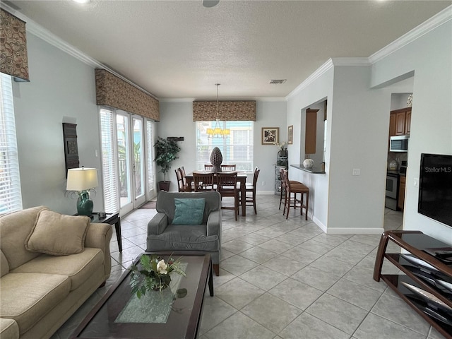 tiled living room featuring a textured ceiling, a chandelier, and ornamental molding