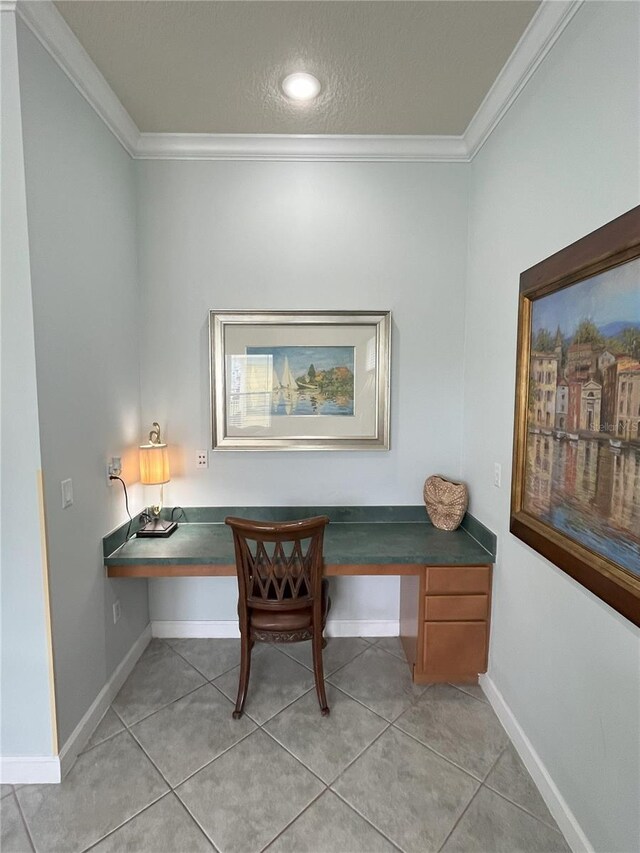 office area featuring crown molding, light tile patterned floors, and built in desk