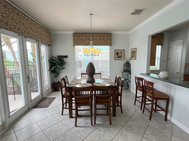 dining space with ornamental molding, a wealth of natural light, and an inviting chandelier