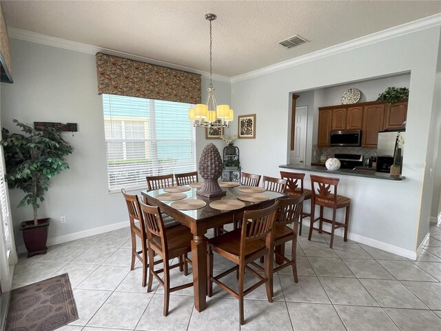 tiled dining room with crown molding, a notable chandelier, and a textured ceiling