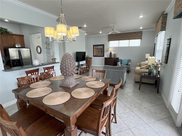 tiled dining room featuring ceiling fan with notable chandelier and ornamental molding