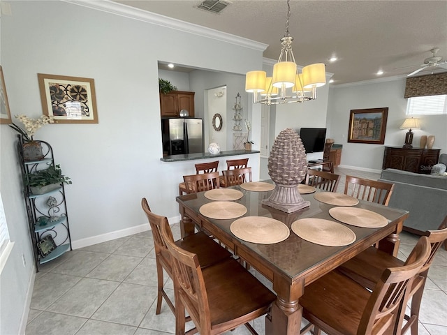 dining space with light tile patterned floors, ceiling fan with notable chandelier, and ornamental molding