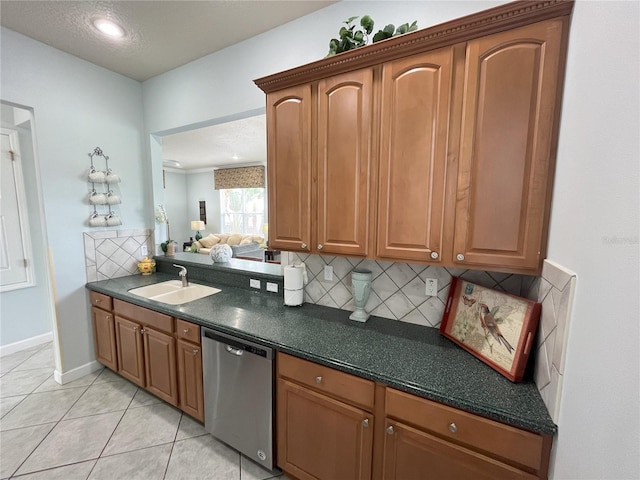 7762 Linkside Loop, Reunion, FL 34747 - kitchen with a sink, stainless steel dishwasher, dark countertops, backsplash, and light tile patterned floors