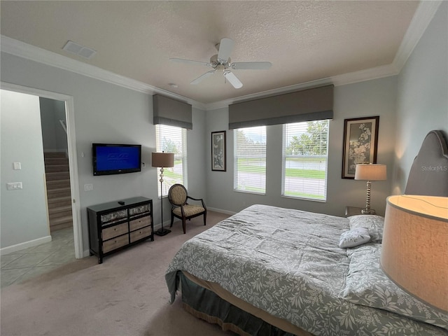 carpeted bedroom with ornamental molding, ceiling fan, and a textured ceiling