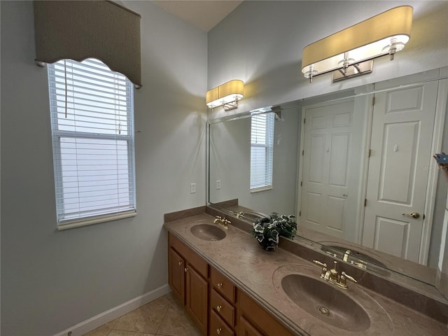 7762 Linkside Loop, Reunion, FL 34747 - bathroom featuring baseboards, double vanity, and tile patterned floors