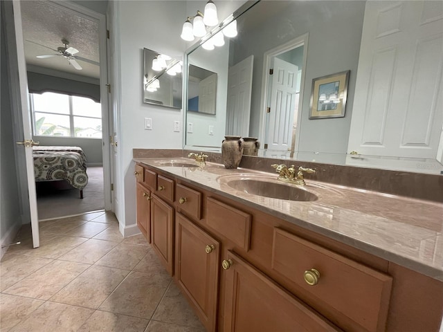 bathroom with tile patterned floors, ceiling fan, vanity, and a textured ceiling