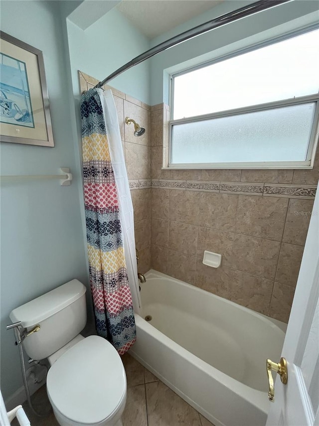 bathroom with tile patterned flooring, shower / bath combo, and toilet