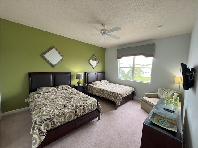 bedroom with a textured ceiling, ceiling fan, and light colored carpet