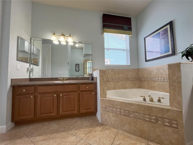 bathroom featuring tile patterned flooring, a relaxing tiled tub, and vanity