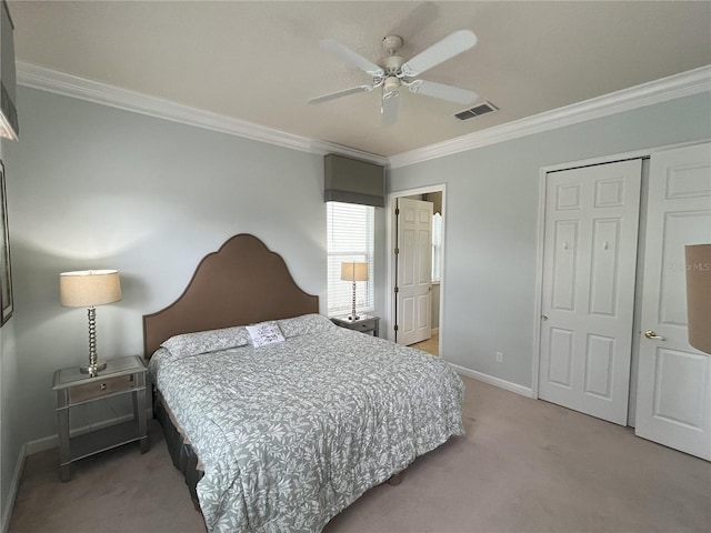 bedroom featuring ornamental molding, ceiling fan, a closet, and carpet flooring