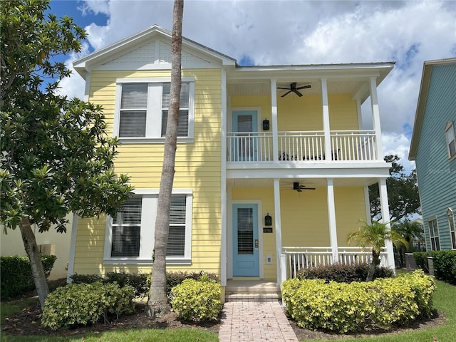 view of front of property featuring ceiling fan, a balcony, and covered porch