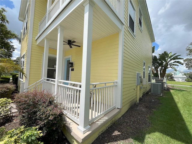 view of home's exterior with ceiling fan, a yard, covered porch, and central AC unit