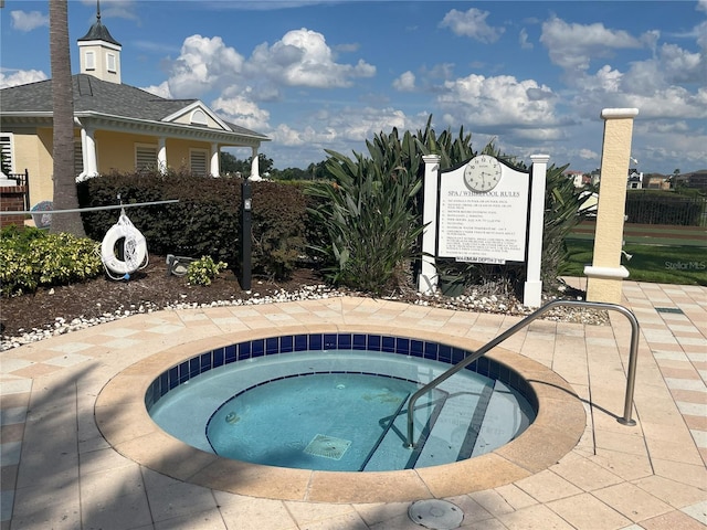 view of swimming pool with a community hot tub