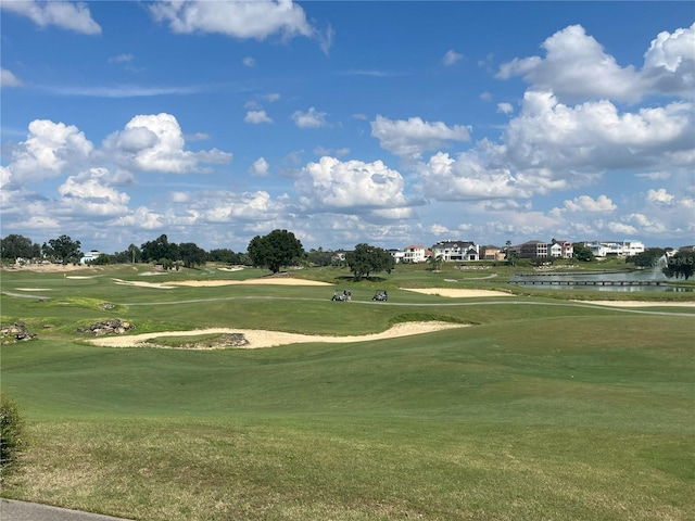 view of property's community featuring a water view and a yard