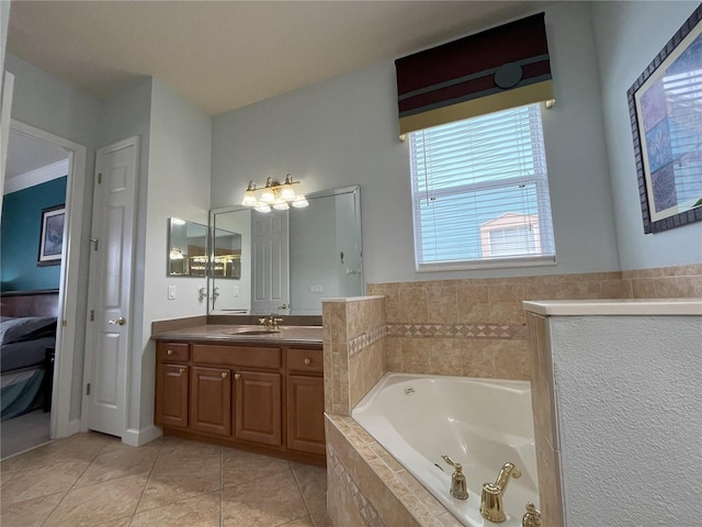 bathroom with tiled tub, vanity, and tile patterned floors