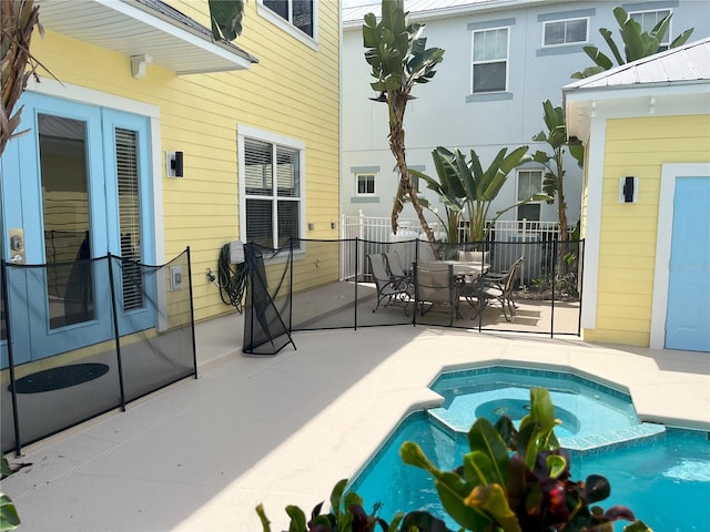 7762 Linkside Loop, Reunion, FL 34747 - view of swimming pool featuring fence, a patio, a pool with connected hot tub, outdoor dining area, and french doors