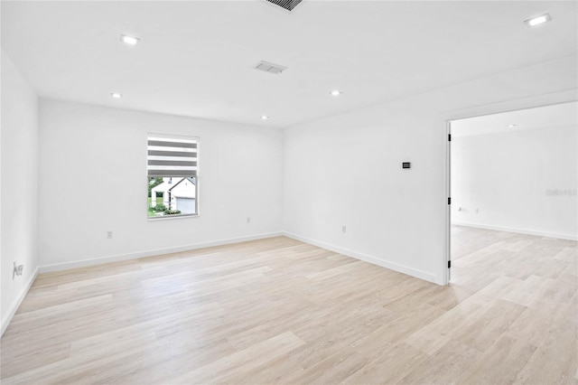 spare room featuring light hardwood / wood-style flooring