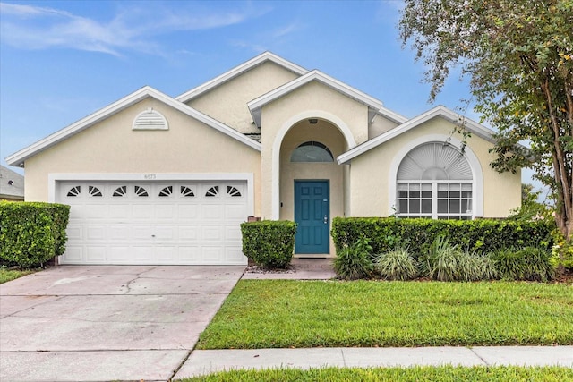 view of front of property featuring a garage and a front yard