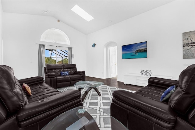 living room with vaulted ceiling with skylight and dark hardwood / wood-style floors