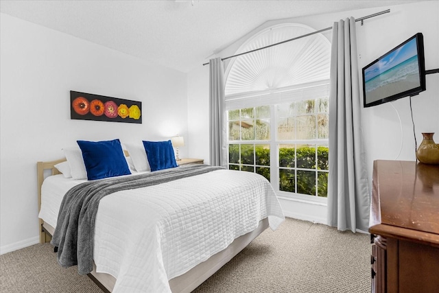 carpeted bedroom with lofted ceiling