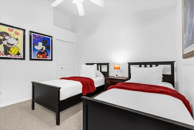 carpeted bedroom with ceiling fan and a closet