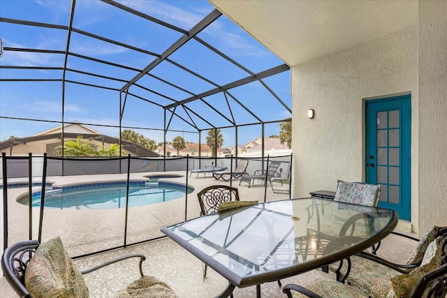 view of swimming pool featuring a lanai and a patio