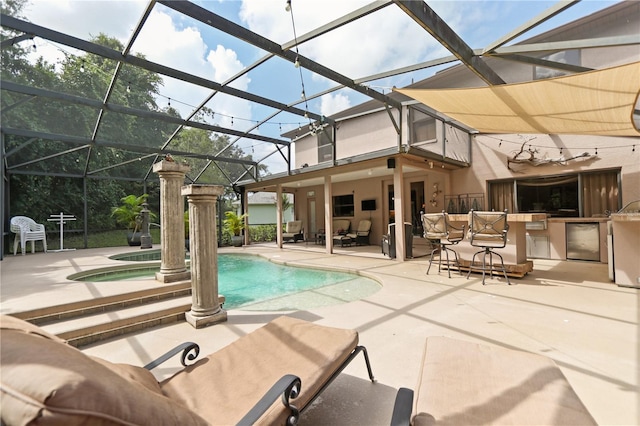 view of swimming pool with glass enclosure, a jacuzzi, an outdoor bar, area for grilling, and a patio