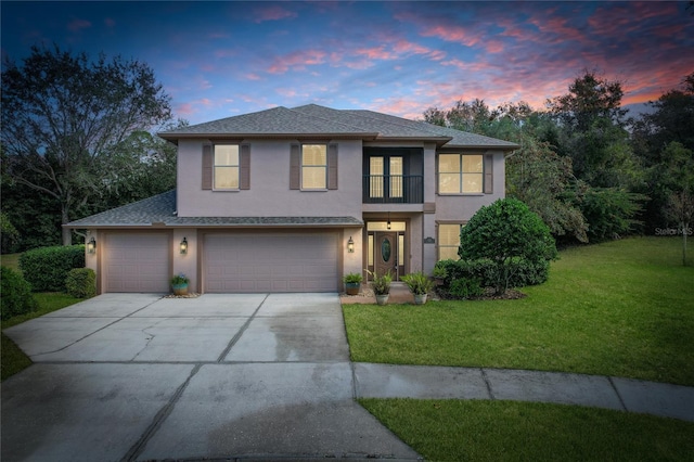 view of front of property with a lawn and a garage