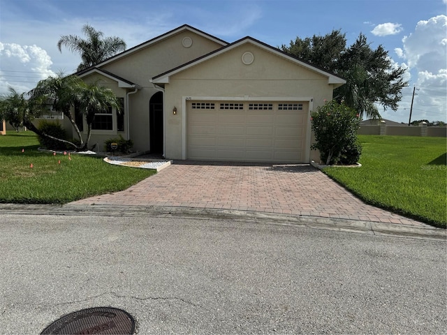 ranch-style house with a garage and a front lawn