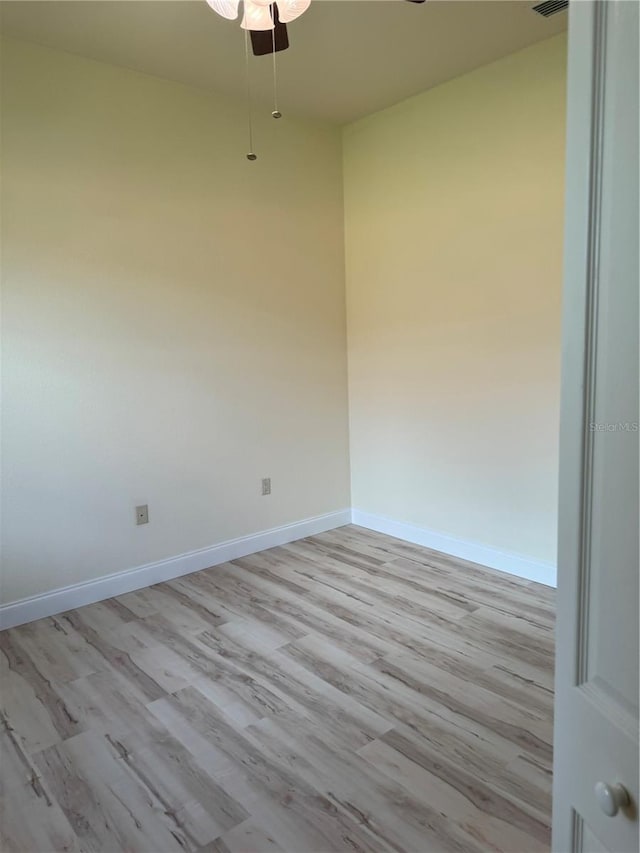 spare room featuring light hardwood / wood-style flooring and ceiling fan