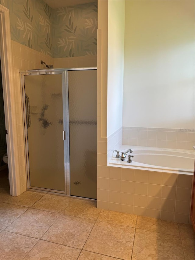 bathroom featuring tile patterned floors, toilet, and separate shower and tub