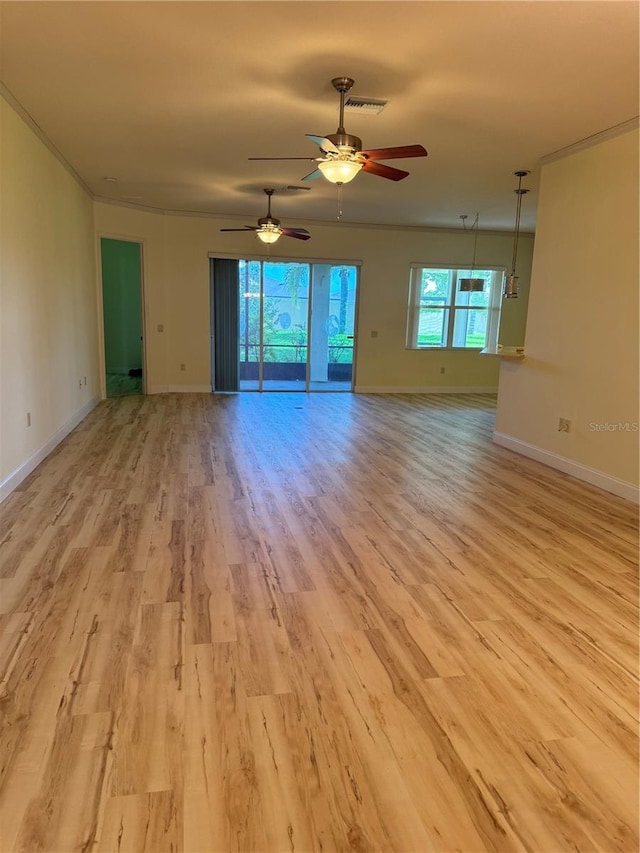 spare room with ceiling fan, light hardwood / wood-style flooring, and a healthy amount of sunlight