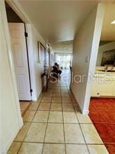 hall featuring light tile patterned flooring