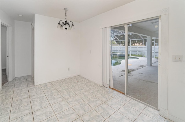 tiled spare room featuring a notable chandelier