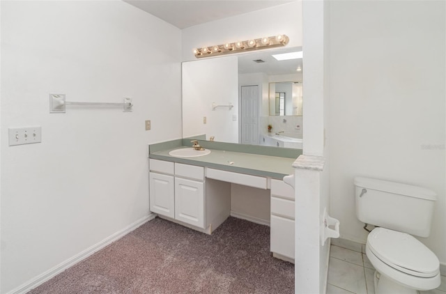 bathroom featuring tile patterned floors, vanity, and toilet