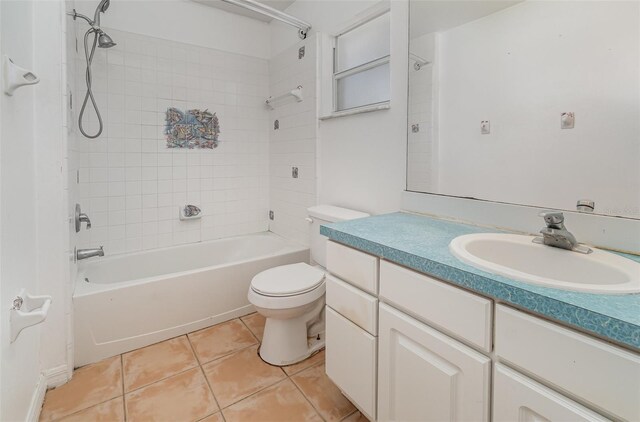 full bathroom with toilet, tile patterned floors, vanity, and tiled shower / bath