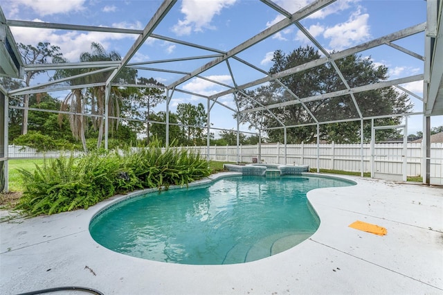 view of pool featuring a patio, an in ground hot tub, and a lanai