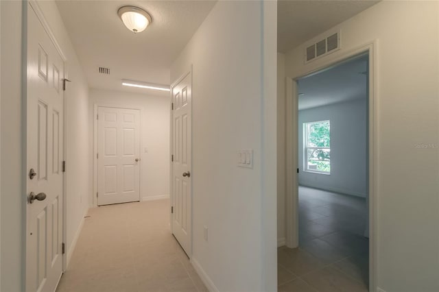 hallway featuring tile patterned floors