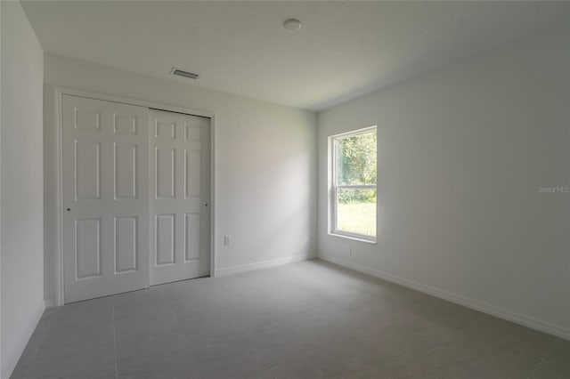 unfurnished bedroom featuring a closet and tile patterned floors