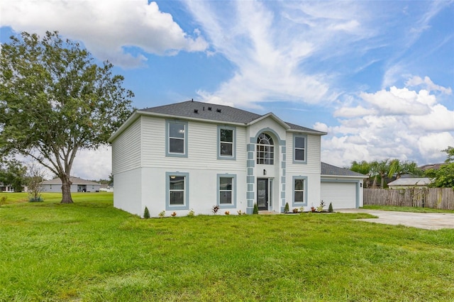 view of front of home featuring a garage and a front lawn