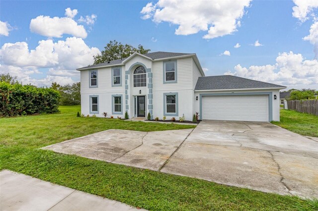 view of front of house featuring a front yard and a garage