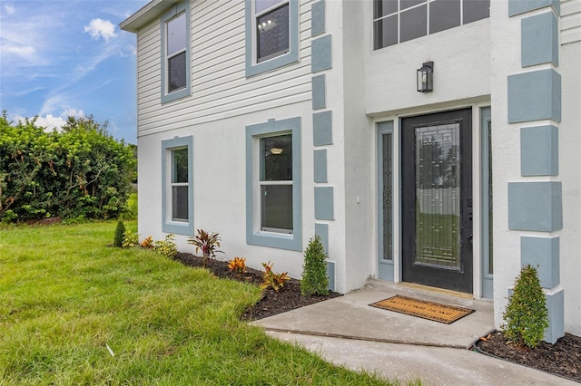 doorway to property featuring a yard