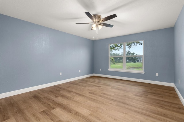 spare room with light hardwood / wood-style floors and ceiling fan