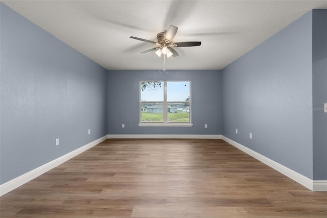 unfurnished room featuring ceiling fan and hardwood / wood-style flooring