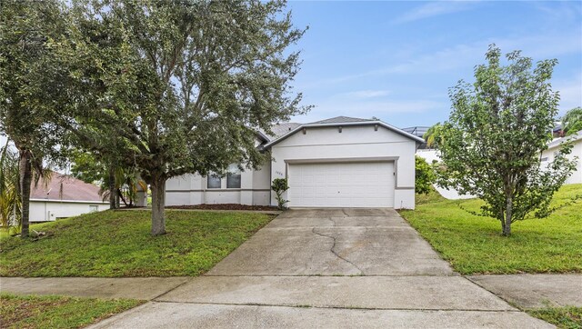 view of front of home featuring a garage and a front lawn