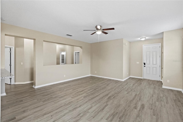 spare room featuring a textured ceiling, ceiling fan, and hardwood / wood-style floors