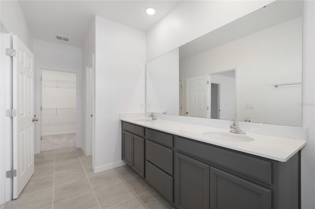 bathroom with tile patterned flooring and double vanity