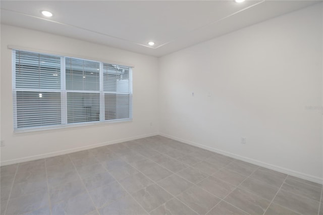 unfurnished room with light tile patterned floors