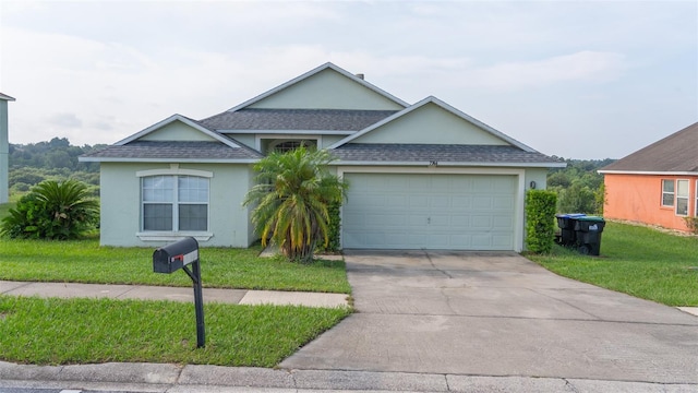 view of front of property featuring a garage and a front lawn