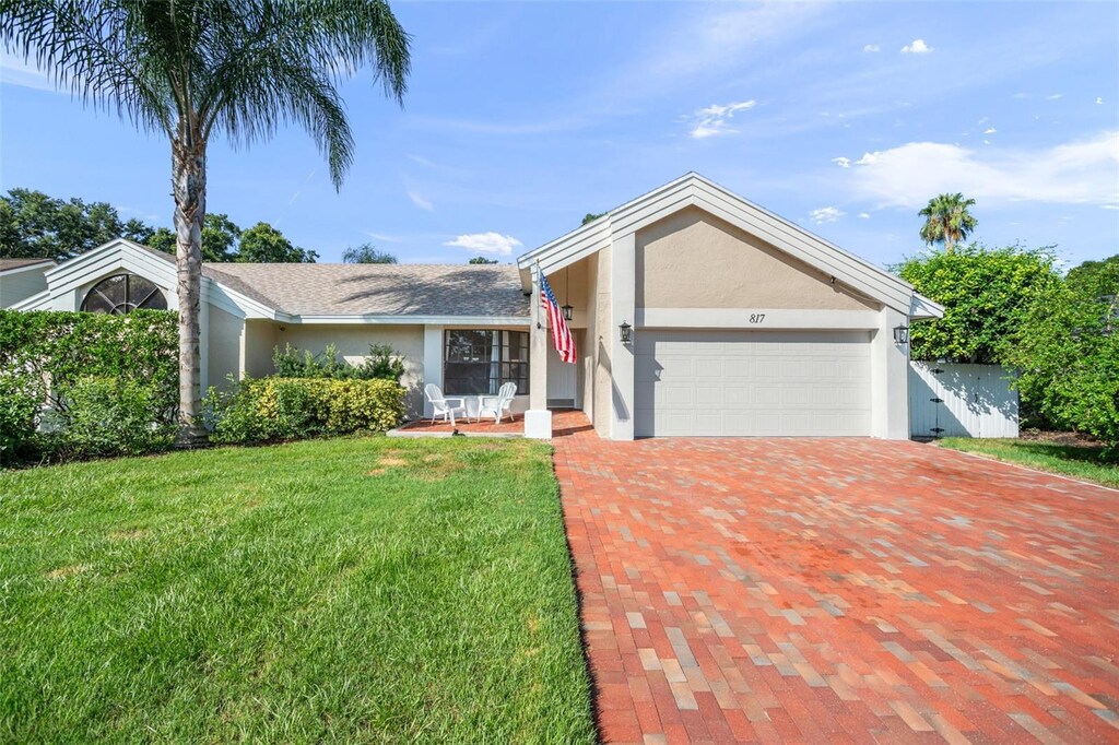 single story home with a garage and a front yard